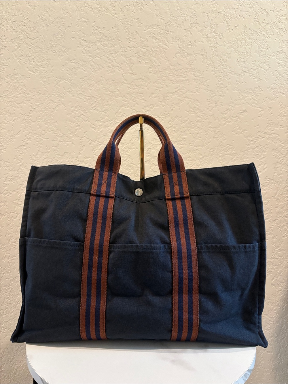 Hermes 12x17 ” Canvas Tote Unisex
- Navy with Brown Straps Handbag